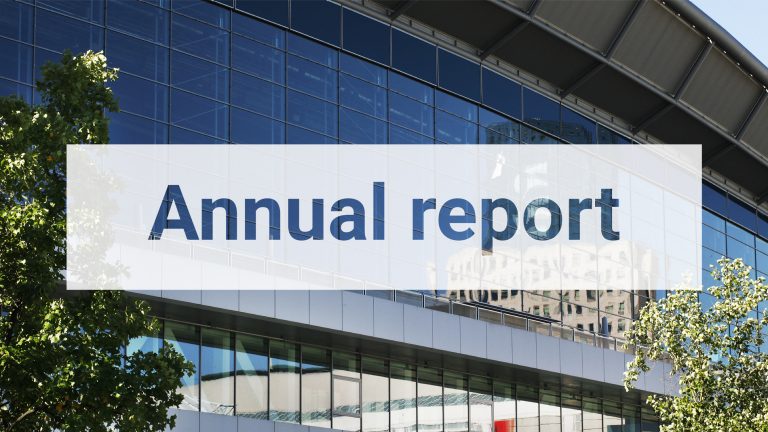 Annual report text displayed over the Messe Frankfurt building, featuring modern glass architecture